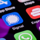 This photo illustration shows the encrypted messaging app Signal (C) pictured on a smartphone home screen in Beijing on March 16, 2021.